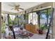 Bright sunroom filled with lush plants and lots of windows, creating a serene indoor-outdoor space at 4722 Oak Hill Ln # 44, Sarasota, FL 34232