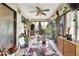 Sunroom featuring tile floor, curtains, a ceiling fan and backyard view at 4722 Oak Hill Ln # 44, Sarasota, FL 34232