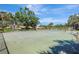 Well-maintained community tennis courts surrounded by lush greenery under a bright blue sky at 4722 Oak Hill Ln # 44, Sarasota, FL 34232