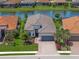 Stunning aerial view of a well-maintained home on a waterfront lot with lush landscaping at 4726 Zeno Ct, Bradenton, FL 34211