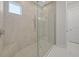 Modern walk-in shower featuring neutral tile and frameless glass doors at 4726 Zeno Ct, Bradenton, FL 34211