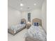 Cozy bedroom featuring two twin beds, modern decor, and a ceiling fan at 4726 Zeno Ct, Bradenton, FL 34211