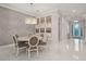 Elegant dining area with stylish chandelier, wainscoting, and access to the home's entryway at 4726 Zeno Ct, Bradenton, FL 34211