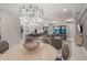 Open-concept dining room with designer lighting fixture and view of kitchen and living areas at 4726 Zeno Ct, Bradenton, FL 34211