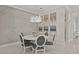 Chic dining room with stylish chandelier, neutral decor, and seating for six around a round table at 4726 Zeno Ct, Bradenton, FL 34211