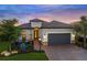 Charming home featuring a landscaped front yard, a brick driveway, and a two-car garage at 4726 Zeno Ct, Bradenton, FL 34211