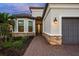Beautiful home with a stone-accented facade, decorative front door, and a well-manicured front yard at 4726 Zeno Ct, Bradenton, FL 34211