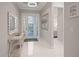 Bright foyer with a decorative mirror, artwork, and a view into the bedroom beyond at 4726 Zeno Ct, Bradenton, FL 34211
