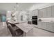 The kitchen features white cabinets, stainless appliances, a marble-topped island with seating and opens to a living space at 4726 Zeno Ct, Bradenton, FL 34211