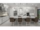 Elegant kitchen featuring a large island with seating, pendant lighting, and modern stainless steel appliances at 4726 Zeno Ct, Bradenton, FL 34211