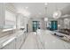 The spacious, bright kitchen boasts white cabinets, stainless steel appliances, and marble countertops with living room view at 4726 Zeno Ct, Bradenton, FL 34211