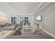 Living room with coffered ceilings and neutral finishes with a view and access to outdoor pool and the modern kitchen at 4726 Zeno Ct, Bradenton, FL 34211