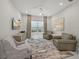 Bright living room featuring a ceiling fan, comfortable seating, and modern decor at 4726 Zeno Ct, Bradenton, FL 34211