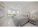 Serene bedroom with a large bed, white tile flooring, and lots of natural light from multiple windows at 4726 Zeno Ct, Bradenton, FL 34211