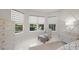 Brightly lit main bedroom with an outdoor view and accent chair beside a window at 4726 Zeno Ct, Bradenton, FL 34211