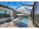 Screened-in pool with a covered patio, poolside seating, and a grill at 4726 Zeno Ct, Bradenton, FL 34211
