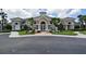 Beautiful community clubhouse featuring stone accents, lush landscaping, and welcoming entrance at 5011 100Th E Dr, Parrish, FL 34219