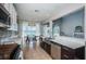 Well-equipped kitchen with stainless steel appliances and dark wood accents open to the dining area and living room at 5011 100Th E Dr, Parrish, FL 34219