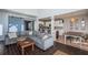 Bright living room with tile flooring, connecting to the kitchen, dining area, and a sliding barn door at 5011 100Th E Dr, Parrish, FL 34219