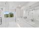 Bright bathroom featuring dual sinks, modern fixtures, large mirror, and walk-in shower at 516 Tamiami S Trl # 102, Nokomis, FL 34275
