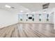 Bright flex room with lots of windows and light, featuring a ceiling fan and modern flooring at 516 Tamiami S Trl # 102, Nokomis, FL 34275