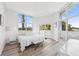 Airy main bedroom with large windows, modern decor, and plenty of natural light creating a serene retreat at 516 Tamiami S Trl # 102, Nokomis, FL 34275