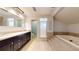 Bathroom featuring a soaking tub, walk-in shower, and double vanity at 5340 Dominica Cir, Sarasota, FL 34233