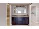 Double vanity bathroom with granite counters, vanity lighting, and large mirror at 5340 Dominica Cir, Sarasota, FL 34233