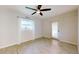 Simple bedroom featuring wood floors, white curtains, and natural lighting at 5340 Dominica Cir, Sarasota, FL 34233