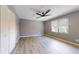 A spacious bedroom features vinyl flooring, a ceiling fan, and a bright window at 5340 Dominica Cir, Sarasota, FL 34233