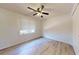 Simple bedroom features hardwood flooring and a window with blinds at 5340 Dominica Cir, Sarasota, FL 34233