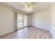 Cozy bedroom featuring wood floors and glass doors to a balcony at 5340 Dominica Cir, Sarasota, FL 34233