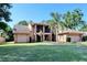 Beautifully landscaped two-story home with a front porch and an attached two-car garage at 5340 Dominica Cir, Sarasota, FL 34233