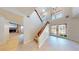 Bright foyer featuring a staircase, tiled floors, and a view into the living room at 5340 Dominica Cir, Sarasota, FL 34233