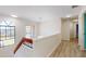 Bright hallway featuring wood floors, transom windows, and natural light at 5340 Dominica Cir, Sarasota, FL 34233