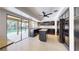Modern kitchen featuring dark cabinetry, stainless steel appliances, and a granite countertop at 5340 Dominica Cir, Sarasota, FL 34233