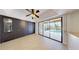 An open living area with floor to ceiling cabinets and sliding glass doors to a covered pool at 5340 Dominica Cir, Sarasota, FL 34233