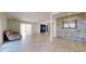Spacious living room with light wood floors and a decorative brick wall at 5340 Dominica Cir, Sarasota, FL 34233