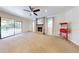 Cozy living room boasts a brick fireplace and sliding glass doors to outdoor living area at 5340 Dominica Cir, Sarasota, FL 34233