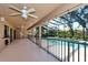 A screened-in patio with ceiling fans overlooks a private pool and lush backyard at 5340 Dominica Cir, Sarasota, FL 34233