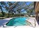 A beautiful backyard has a screened-in pool and green landscaping at 5340 Dominica Cir, Sarasota, FL 34233