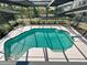 A screened-in pool area features diving board, steps and landscaped backyard at 5340 Dominica Cir, Sarasota, FL 34233