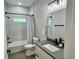 Elegant bathroom features modern fixtures, stylish vanity, and shower with a sleek white and gray tile surround at 5473 Gagnon Ter, North Port, FL 34291