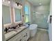 Elegant bathroom featuring a double sink vanity, freestanding tub, and a glass-enclosed shower with marble tile at 5473 Gagnon Ter, North Port, FL 34291