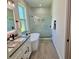 Modern bathroom with double sink vanity, freestanding tub, and glass-enclosed shower with marble-look tile at 5473 Gagnon Ter, North Port, FL 34291