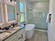 Stylish bathroom with double sink vanity, soaking tub, and a sleek glass shower, all illuminated by natural light at 5473 Gagnon Ter, North Port, FL 34291