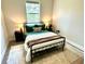 A cozy bedroom with a black bed frame, plush bedding, and bedside lamps for a warm ambiance at 5473 Gagnon Ter, North Port, FL 34291