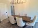 Bright dining room featuring a wooden table with 6 chairs under an ornate chandelier with wood-look flooring at 5473 Gagnon Ter, North Port, FL 34291