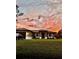 Charming single-story home with a well-maintained lawn and a picturesque sunset backdrop at 5473 Gagnon Ter, North Port, FL 34291
