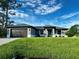 Beautiful single-story home with a neatly manicured lawn and neutral-toned exterior under a sunny sky at 5473 Gagnon Ter, North Port, FL 34291